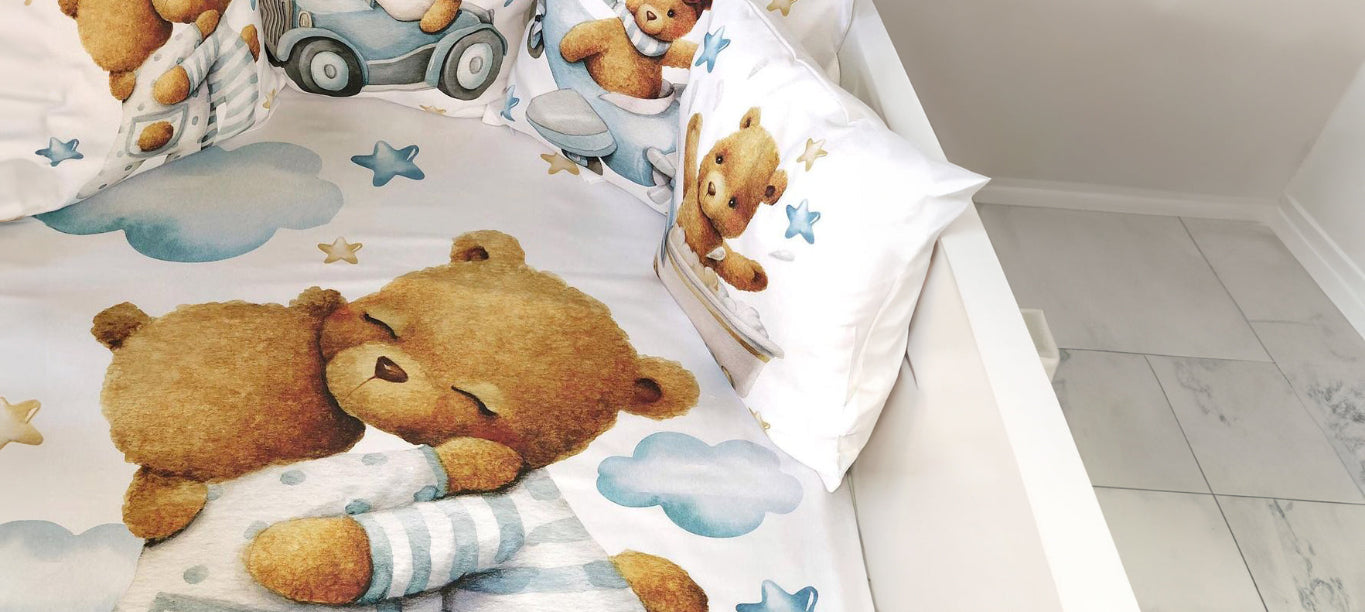 Children's room with teddy bear-themed bedding and pillows.