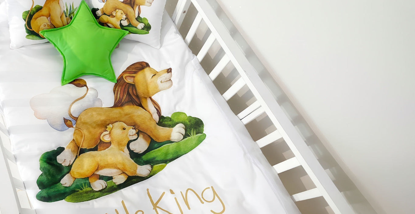 Crib with lion-themed bedding and green star