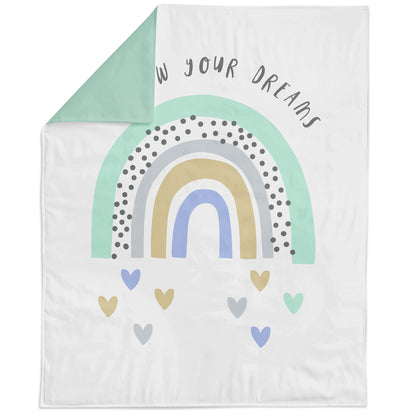 A fabric panel with a rainbow pattern and text that reads 'With your dreams' on it, indicating it is designed for quilting or crafting.