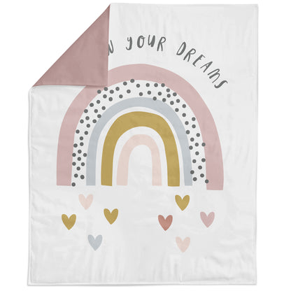 A fabric panel featuring a rainbow with hearts at the bottom, and text that says 'Use your dreams'.