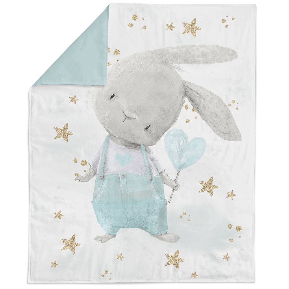 A fabric panel featuring a cute bunny design with blue background and gold stars and hearts.