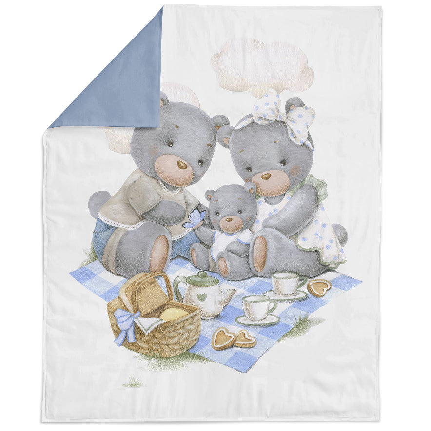 A fabric panel featuring a cartoon bear with a picnic basket and a teacup, set against a blue background with a checkered pattern.