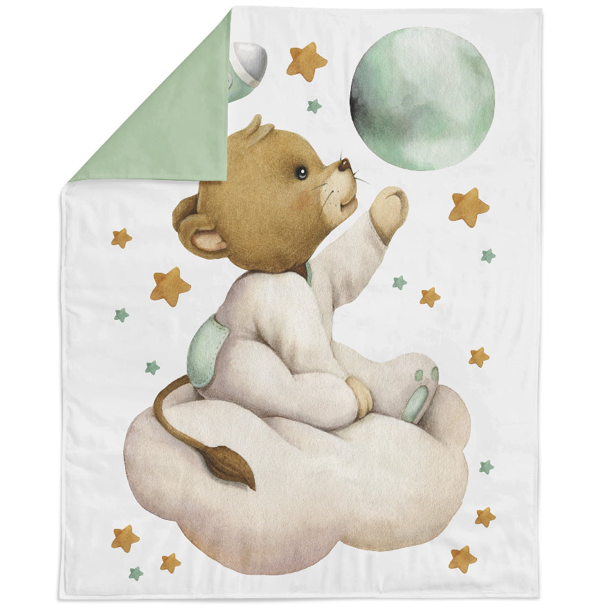 Blanket with baby lion sitting on a cloud, with a white background and stars around. 