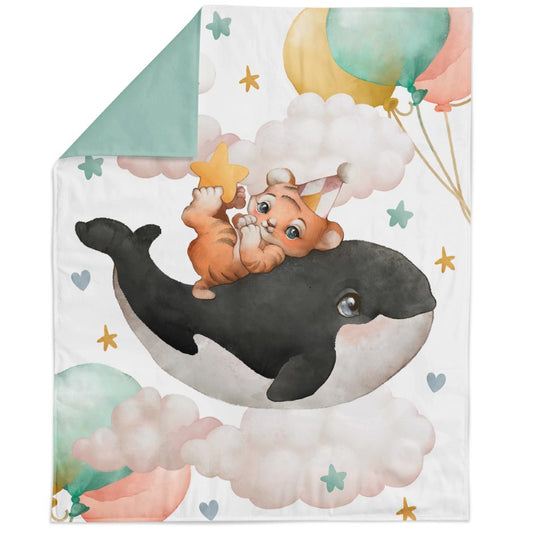 A fabric panel featuring an illustration of a cat riding on a whale with a background of stars, balloons, and a green border.