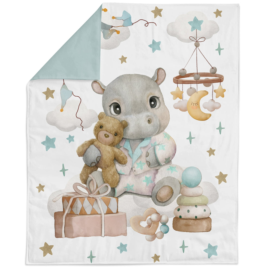 Baby blanket with a hippo character holding a teddy bear, surrounded by toys and stars on a white background.