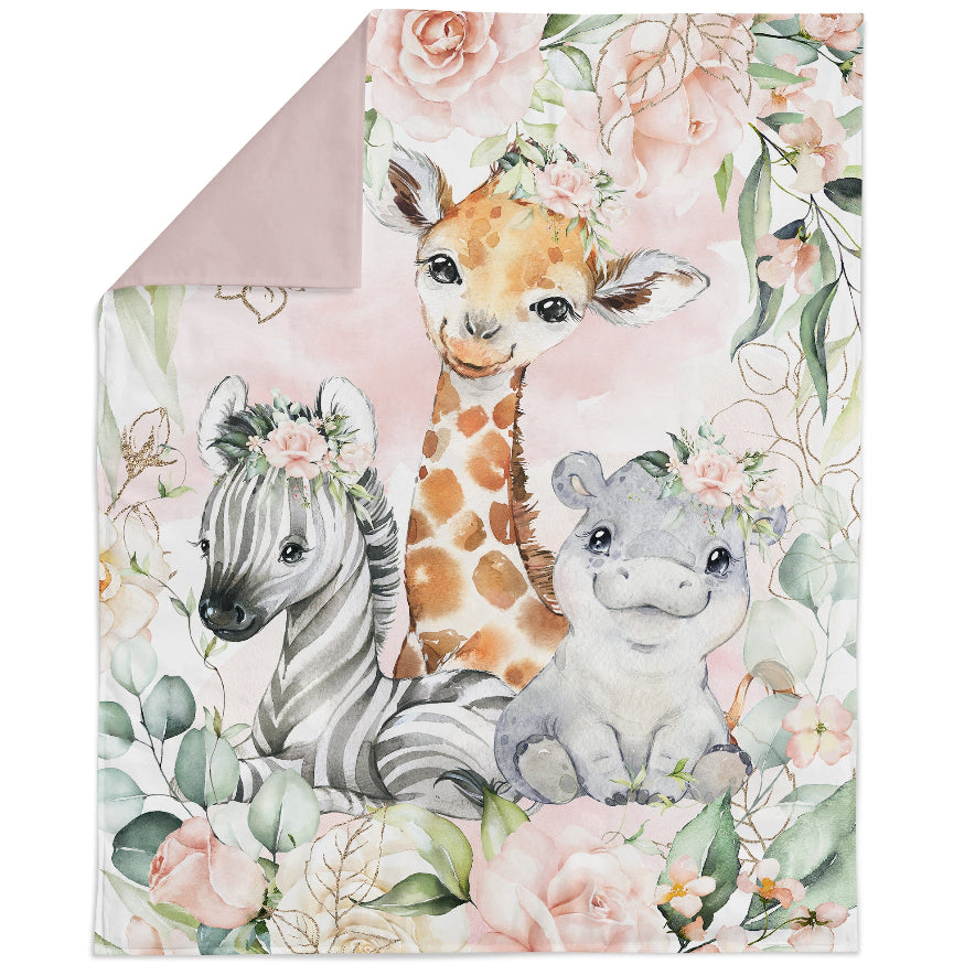 Fabric panel with a safari animal theme, featuring a giraffe, zebra, and antelope among floral patterns, on a pink background.