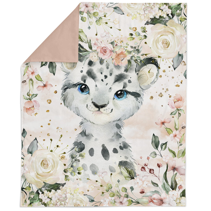 A fabric panel featuring a cartoon-style animal, possibly a leopard or a cheetah, surrounded by a floral pattern with pink and blue flowers and green foliage.