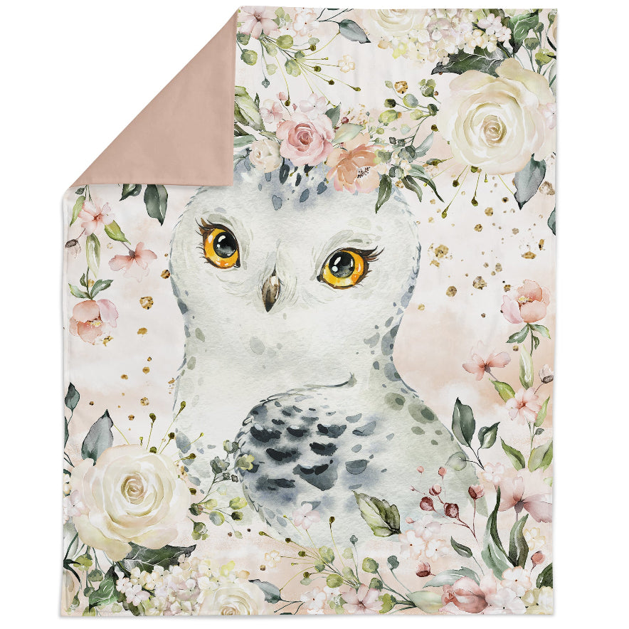 A fabric panel featuring an illustrated owl amidst a floral pattern with various colors such as pink, green, and white.